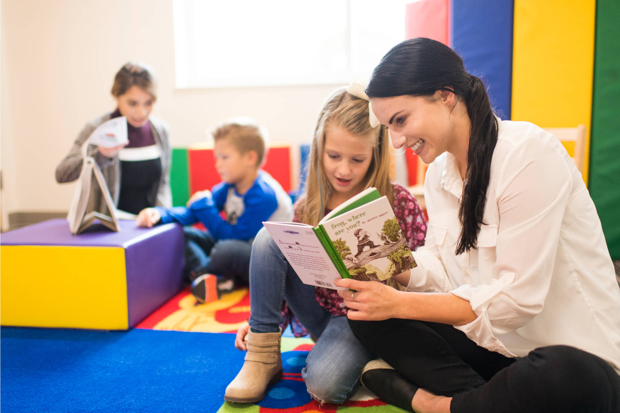 A student-teacher reads with an elementary school student.